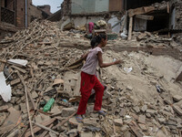A girl is pictured as she's standing in the middle of the rubble where her house was before the earthquake.
2 weeks after the powerful and d...