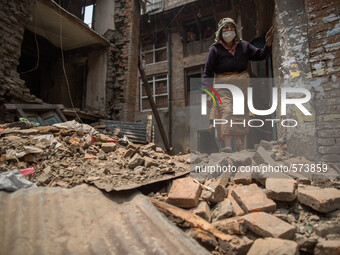 A woman pass through a collapsed house.
2 weeks after the powerful and deadly earthquake, a view of the oldest city in Nepal, Bakhtapur.
The...