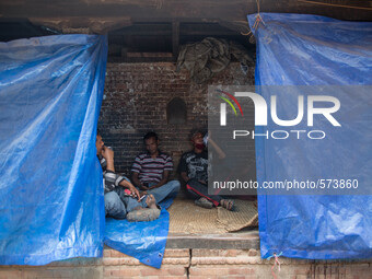 Men are pictured as they are sitting inside a temporary tiny shelter.
2 weeks after the powerful and deadly earthquake, a view of the oldest...