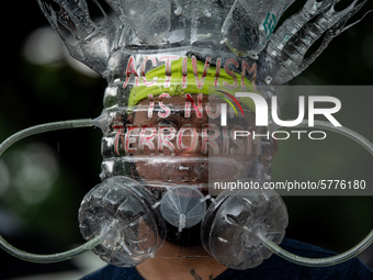 A man wearing a face shield made of recycled materials joins a protest against the Anti-Terror Bill on June 12, 2020 at the University of th...