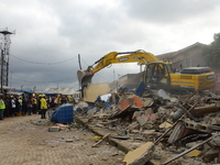 Officials Lagos State Emergency Management demolishing the remains of the building, after a building collapse at Gafari Balogun street, Ogud...