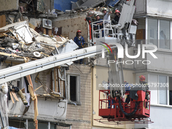 Ukrainian rescue workers clean debris after a suspected gas explosion  in an apartment building in Kyiv, Ukraine, 21 June 2020.  (