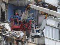 Ukrainian rescue workers clean debris after a suspected gas explosion  in an apartment building in Kyiv, Ukraine, 21 June 2020.  (