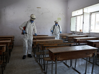 Members of civil defense known as white helmets sterilize school classes after discovering 3 COVID-19 cases in Idlib, Syria on July 11, 2020...