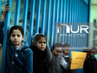 Palestinian children during a protest in front of the headquarters of UNRWA and Works Agency to demand the lifting of the siege on Gaza City...
