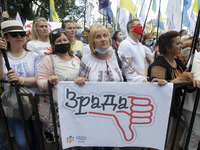 Ukrainians take part at a rally in support Ukrainian language and against a bill which offers to extend the use of the Russian language in U...