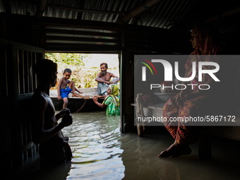 Flood-affected family are seen on a boat after their houses got flooded, in Bogura, Bangladesh, on July 20, 2020.  (