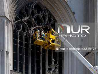 Workers cleaning up fractured stones on the facade of Saint-Pierre et Saint-Paul cathedral in Nantes, France, on July 21, 2020 in order to l...