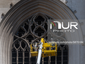 Workers cleaning up fractured stones on the facade of Saint-Pierre et Saint-Paul cathedral in Nantes, France, on July 21, 2020 in order to l...