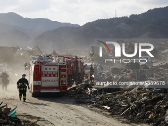 March 18, 2011-Rikuzen Takata, Japan-Rescue Team exhumation burial body at Debris and Mud covered on Tsunami hit Destroyed city in Rikuzenta...