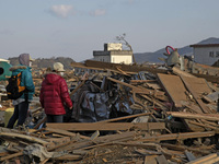 March 18, 2011-Rikuzen Takata, Japan-Native Survivors find their house lot at Debris and Mud covered on Tsunami hit Destroyed city in Rikuze...