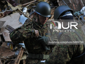 March 18, 2011-Rikuzen Takata, Japan-Military searching operation on Debris and Mud covered at Tsunami hit Destroyed city in Rikuzentakata o...