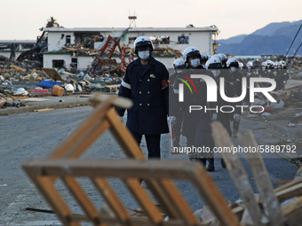 March 18, 2011-Rikuzen Takata, Japan-Rescue Team stop searching after going to their camp at Debris and Mud covered on Tsunami hit Destroyed...