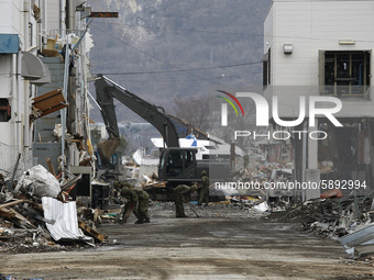 March 21, 2011-Ofunato, Japan-Military clean up to debris and mud covered at Tsunami hit Destroyed Industrial Area in Ofunato on March 21, 2...
