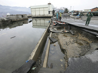 March 21, 2011-Ofunato, Japan-Government officers check to crack road on debris and mud covered at Tsunami hit Destroyed Industrial Area in...