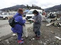 March 21, 2011-Ofunato, Japan-Volunteer relief activity on debris and mud covered at Tsunami hit Destroyed Industrial Area in Ofunato on Mar...