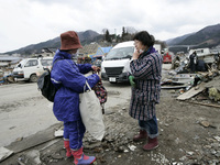 March 21, 2011-Ofunato, Japan-Volunteer relief activity on debris and mud covered at Tsunami hit Destroyed Industrial Area in Ofunato on Mar...