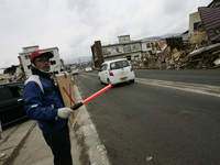 March 21, 2011-Ofunato, Japan-Gas station employee reopen business on debris and mud covered at Tsunami hit Destroyed Industrial Area in Ofu...