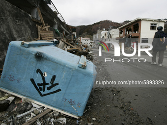 March 25, 2011-Kamaishi, Japan-Native survivors leaving their house on debris and mud covered at Tsunami hit Destroyed mine town in Kamaishi...