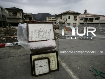 March 25, 2011-Kamaishi, Japan-Picture frame and watch displayed road side to debris and mud covered at Tsunami hit Destroyed mine town in K...