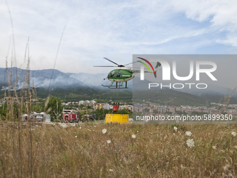 The Canadairs and the Civil Protection and Carabinieri Corps helicopters launch water over the vast fire, L'Aquila, Italy, on August 1, 2020...