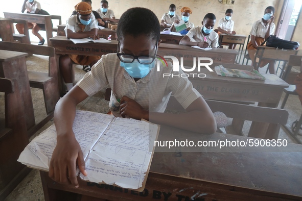 Final year students of Agidingbi Senior Grammar School, Ikeja, Lagos, Nigeria with facemasks sit in a classroom as they resume school after...