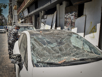 A damaged car is seen the day after a massive explosion at the port on August 5, 2020 in Beirut, Lebanon. According to the Lebanese Red Cros...