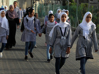 Students walk to the United-Nation run Elementary School on the first day of the new school year as Palestinians ease the coronavirus diseas...