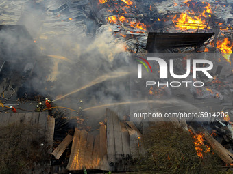 Officers extinguish the fire when a fire ravaged the wooden furniture factory building in Cakung, Jakarrta, on August, 9,2020. 30 units of f...