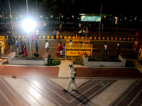 People lineup with social distancing measures outside Birla Mandir ahead of the Hindu festival of Krishna Janmashtami on August 12, 2020 in...
