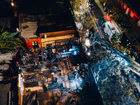 Drone view of a fire in *cite in downtown Santiago, more than 15 fire trucks attended. (*type of bulding with many rooms, usually 2 floors w...