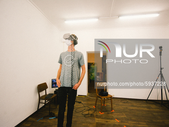 a visitor with a face mask experiences VR in a small studio at places-Visual reality festival in Gelsenkirchen, Germany, on August 21, 2020....