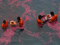Volunteers immerse idols of the Hindu god Ganesh, in an artificial pond during the Ganesh Chaturthi festival in Mumbai, India on August 23,...