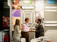 Several people at the stand of the brand wallstil during the Construmat fair in Barcelona on May 19, 2015 (