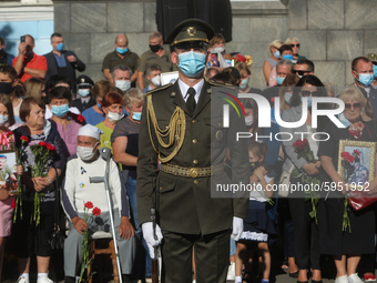 Honor Guard soldier stand next to fallen heroes families during the commemorative ceremony at the territory of Defence Ministry in Kyiv, Ukr...