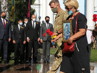 Families of killed soldiers and authorities lay flowers to the Monument of Fallen Heroes during the commemorative ceremony at the territory...