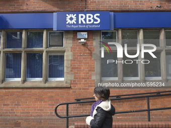 A person passing beneath a sign for the Royal Bank of Scotland on Tuesday 19th May 2015. --  Barclays Bank and the Royal Bank of Scotland, a...