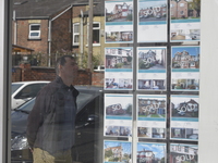 Light shining through an estate agent's window as a person views the availability of property in Manchester on Tuesday 19th May 2015. -- The...
