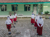 Students line up before entering the classroom at Candirejo Elementary School, Semarang Regency, Central Java, Indonesia, on September 1, 20...