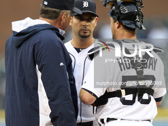 Detroit Tigers pitching coach Jeff Jones (L) talk to starter Anibal Sanchez as catcher Bryan Holiday listens in during the third inning of a...