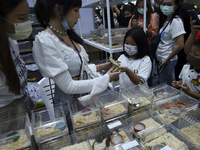Visitors look at snakes in boxes at the Pet Expo Thailand 2020 in Bangkok, Thailand, on September 06, 2020. (