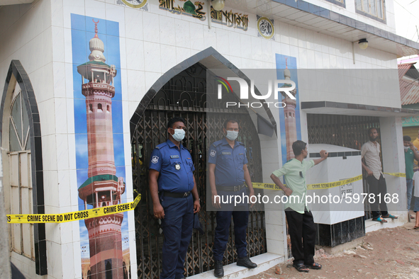 Law enforcers stand guard in front of a mosque after a gas pipeline explosion as killed 24 people in Nayaranganj, in Bangladesh on September...