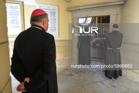 Members of the clergy seen praying next to Cardinal Marian Jaworski's coffin ahead of the funeral mass inside the Bernardine monastery in Ka...
