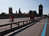 A cyclist crosses Westminster Bridge, heading south away from the Houses of Parliament in London, England, on September 14, 2020. (