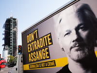 A billboard van calling for an end to extradition proceedings against WikiLeaks founder Julian Assange waits at traffic lights in Parliament...