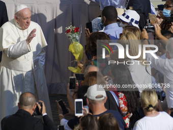Pope Francis greets faithful wearing face masks to prevent the spread of COVID-19 as he arrives in the St. Damaso courtyard on the occasion...