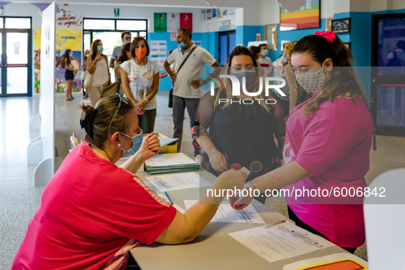 A collaborator measures the temperature of the students' parents to enter the Don Tonino Bello High School in Molfetta on 16th September 202...