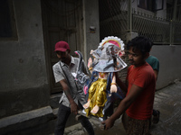 Nepalese devotees carrying Hindu God Vishwakarma, which is being transported to the different parts of Kathmandu Valley to worship at Lalitp...