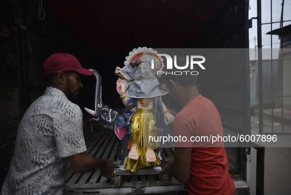 Nepalese devotees carrying Hindu God Vishwakarma, which is being transported to the different parts of Kathmandu Valley to worship at Lalitp...