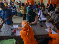 Officers serve residents to get Cash Social Assistance (BST) money at the Palu Post Office, Central Sulawesi Province, Indonesia on Septembe...
